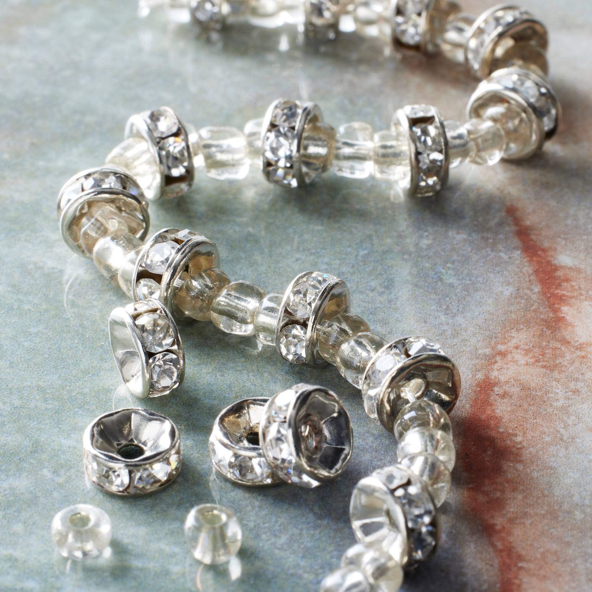 12 Pack: Silver Rhinestone Studded Rondel Beads, 7mm by Bead Landing™